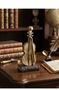 Detailed view of a vintage violin sculpture on a retro book base for home decor