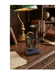 Vintage musical instrument ornament on book base atop a classic wooden study desk