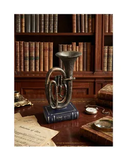 Close-up view of a vintage retro tuba instrument ornament on a book base in a study