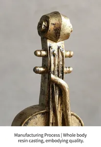 Macro detail of the vintage gold-finished resin texture on a retro violin ornament statue.