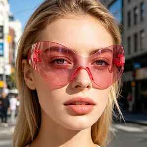 Close-up of oversized pink Y2K cat-eye sunglasses with transparent wrap-around lenses