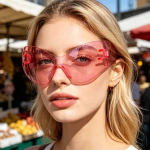 Close-up of trendy pink Y2K cat-eye cycling shield sunglasses worn by a blonde model.