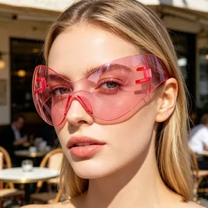 Close-up detail view of a model wearing futuristic pink Y2K shield sunglasses outdoors.