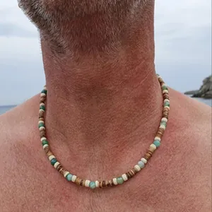Close-up detail of men's bohemian beaded necklace with natural wood and green stone