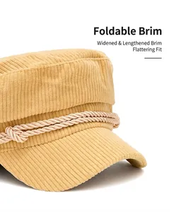 Detailed close-up of a mustard yellow corduroy navy cap with decorative rope and wide brim