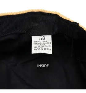 Close-up detail of corduroy navy cap interior with size 58 label and cotton blend lining