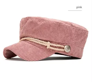 Side view detail of pink corduroy newsboy hat featuring twisted rope and metal button
