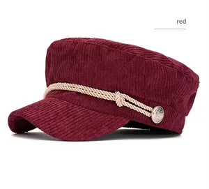 Side view of a burgundy corduroy navy cap featuring rope and silver button details