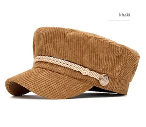 Detail view of a stylish khaki corduroy navy hat with braided rope and metal button decor