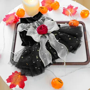 Close-up of black velvet pet dress with silver bow and red rose detail for Halloween
