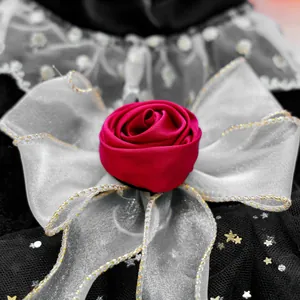Close-up of red fabric rose and white bow detail on luxury pet party dress for dogs