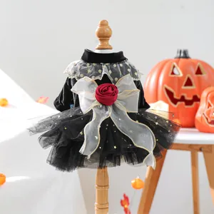 Detailed view of the black velvet pet dress with a large bow and rose ornament