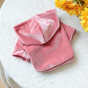 Close-up of pink velvet pet hoodie showing soft fabric texture and hood detail