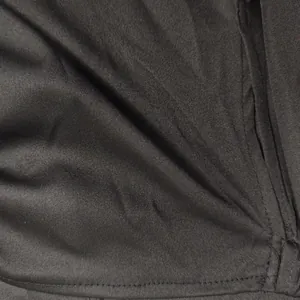 Detailed macro view of the black dress fabric texture and professional hem stitching