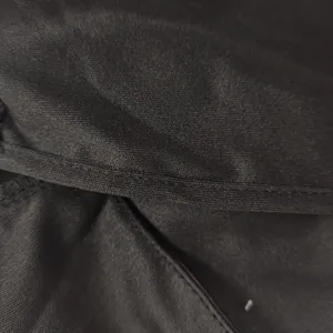 Close-up detail of black fabric texture and stitching on a summer dress