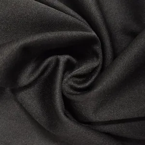 Close-up of soft black pleated fabric showing fine woven texture and soft folds