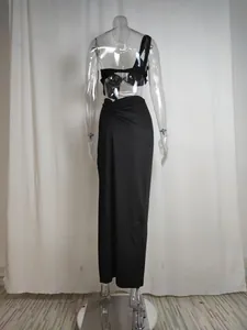Rear view of a stylish black one-shoulder cutout long dress displayed on a mannequin