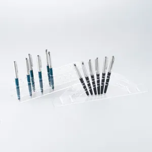 Clear acrylic tiered display stand for fountain pens and eyebrow pencils on desks