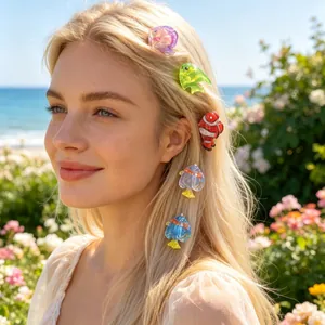 Colorful fish-shaped hair clips worn on blonde hair with a sunny beach background