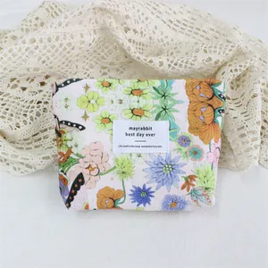 Floral print corduroy makeup bag with butterfly pattern and mayrabbit fabric text label