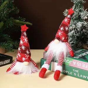 Detailed view of two Christmas gnomes with knitted hats on a decorative book stack
