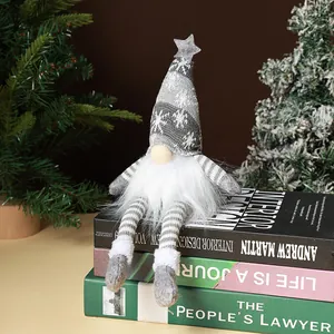 Detailed shot of a plush Christmas gnome ornament sitting on books with festive trees
