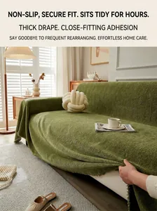 Detailed view of the green herringbone textured fabric on a stylish sofa cover