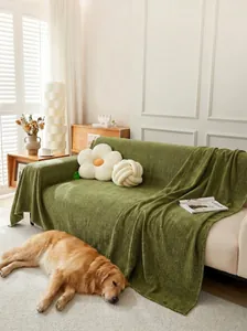 Green herringbone chenille sofa cover blanket displayed in a cozy living room scene