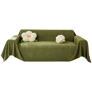 Green herringbone textured sofa cover blanket draped over a couch on white background