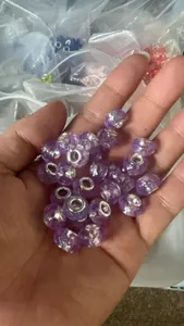 Detailed view of purple faceted glass beads with silver cores for DIY jewelry bracelets