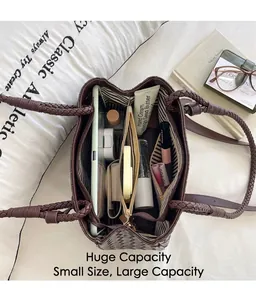Detailed top view of a brown woven bucket handbag showing spacious interior compartments