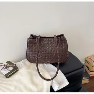 Elegant brown woven leather tote bag for women featuring braided shoulder straps