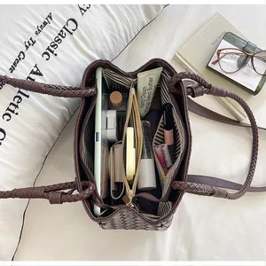 Interior view of a brown woven tote bag showing its large capacity and compartments.