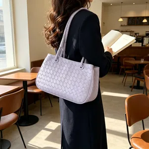 Fashionable lavender woven shoulder bag for women shown in a stylish cafe lifestyle setting