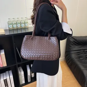Elegant brown woven leather shoulder bag for women in a stylish lifestyle setting