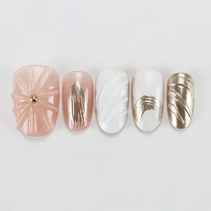 Close-up detail of premium press-on nails featuring 3D textures and elegant gold accents