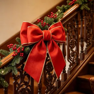 Detail of a large red velvet Christmas bow with gold wire edges on a festive staircase