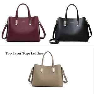 Detailed view of women's top grain togo leather handbags in burgundy black and khaki