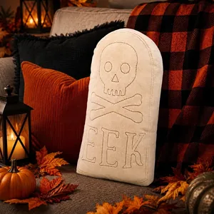 Detail of tombstone plush pillow with embroidered skull and EEK text for Halloween