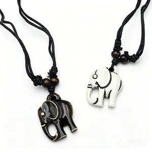 Gedetailleerde weergave van hars olifant hangers in tribal stijl, zwart en gebroken wit