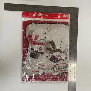 Detail of Christmas knitted placemat with snowman pattern and measurement ruler tool