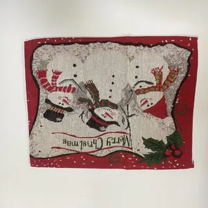 Close-up of Christmas knitted placemat with snowman pattern and Merry Christmas text.