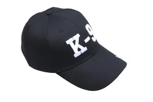 Nahaufnahme einer schwarzen taktischen Baseballkappe mit hochwertiger weißer K-9 Bestickung