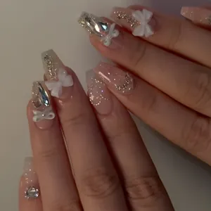 Close-up of handmade press-on nails with elegant 3D white bow ties and cat-eye effect