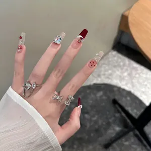 Close-up of luxury handmade press-on nails featuring cat-eye effect and rhinestone accents.