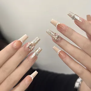 High-end handmade press-on nails with 3D bows, rhinestones and elegant nude gradient.