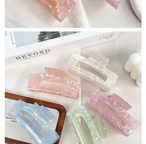 Detail view of colorful iridescent mermaid hair claw clips in various pastel shades