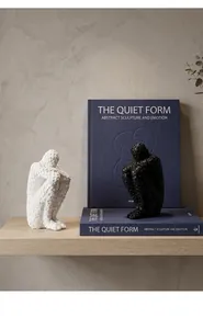 Modern abstract human sculptures in black and white crouching poses for luxury home decor