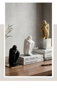 Professional close-up of modern abstract mosaic sculptures in black, white, and gold