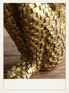 Detailed macro shot of modern golden sculpture featuring a unique 3D square texture design